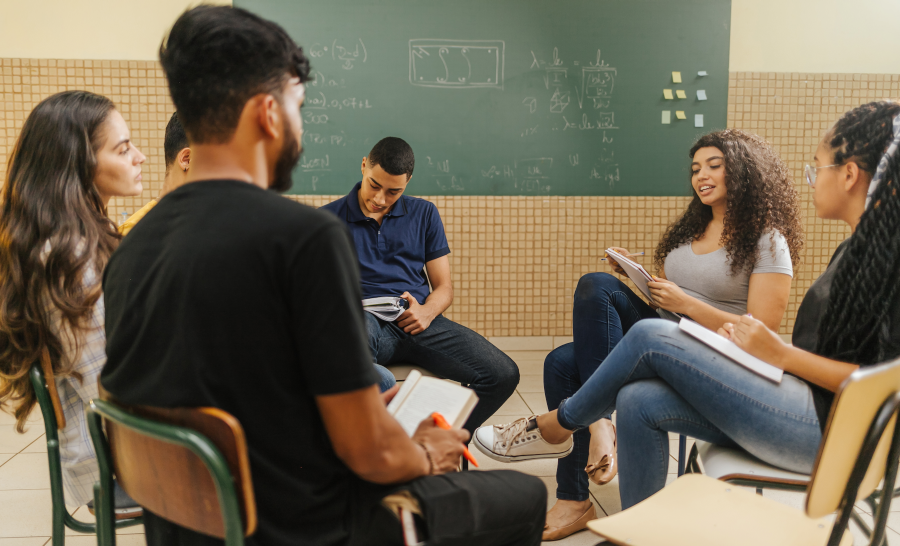 Latinx students seated in a small group circle